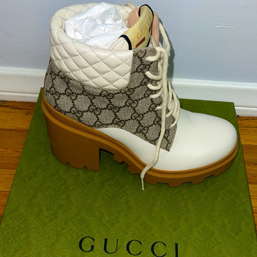 Gucci authentic boots Snake logo on bottom Worn once With shoe bags and box.